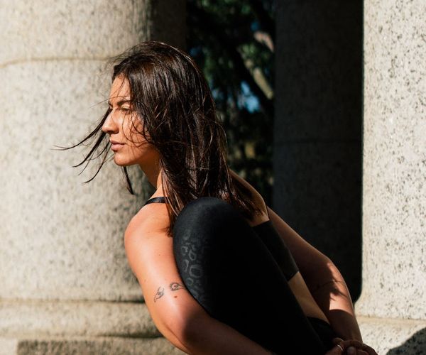Person doing a deep forward bend yoga stretch, showing flexibility.